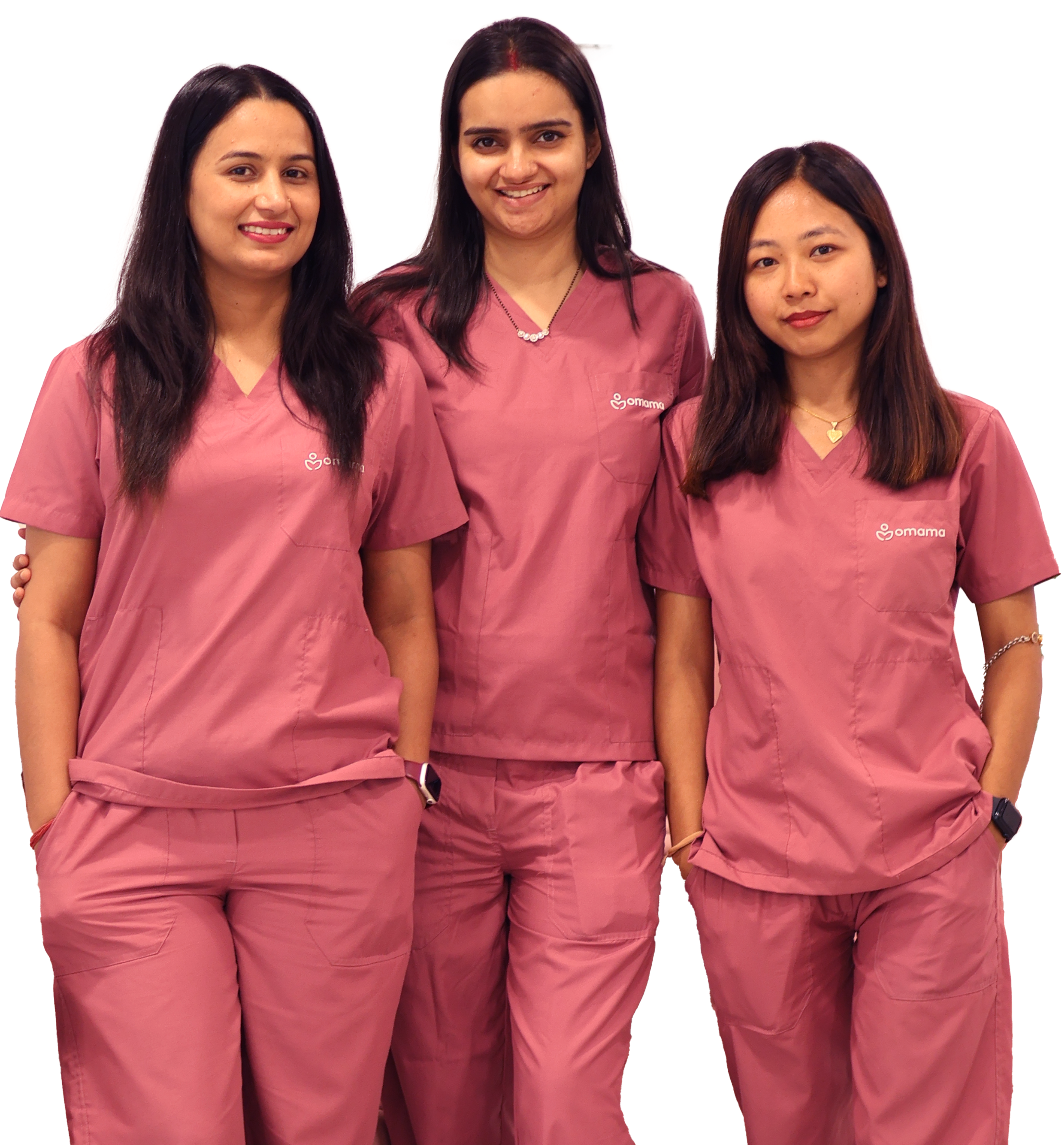 Team of three women in pink medical scrubs smiling, representing postpartum care services